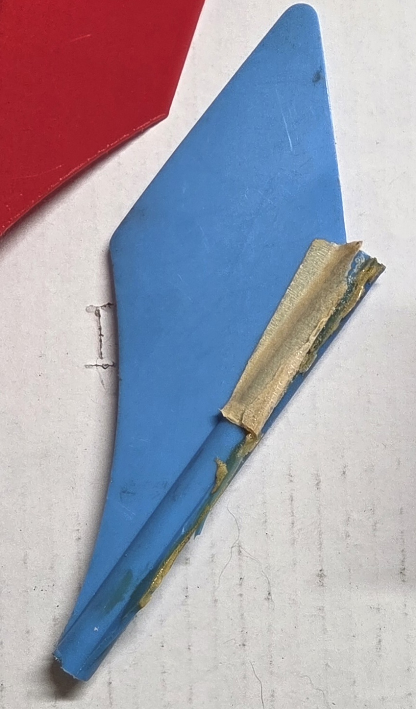 Close-up of a cracked blue plastic fin from a vintage lawn jart